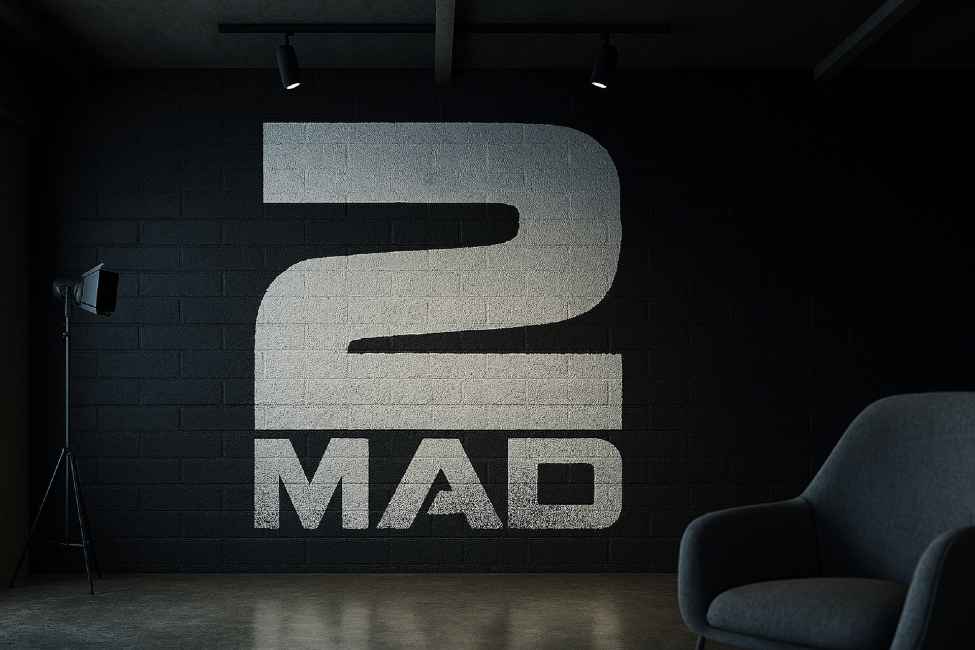 The 2MAD stencil logo spray-painted across a studio wall.