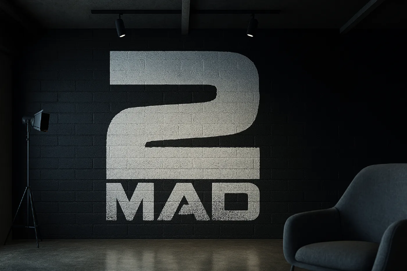 The 2MAD stencil logo spray-painted across a studio wall.